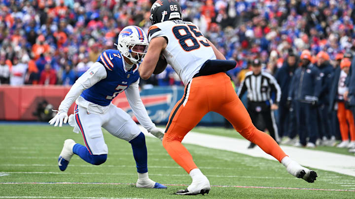 Jan 12, 2025; Orchard Park, New York, USA; Denver Broncos tight end Lucas Krull (85) is tackled by Buffalo Bills cornerback Taron Johnson (7) during the second quarter in an AFC wild card game