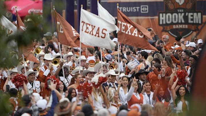 Nov 28, 2025; Austin, Texas, USA; Texas Longhorns flags are carried by the Marching Band during the Bevo Parade before a game against the Texas A&M Aggies at Darrell K Royal-Texas Memorial Stadium. Mandatory Credit: Scott Wachter-Imagn Images Nov 28, 2025; Austin, Texas, USA; Texas Longhorns flags are carried by the Marching Band during the Bevo Parade before a game against the Texas A&M Aggies at Darrell K Royal-Texas Memorial Stadium. Mandatory Credit: Scott Wachter-Imagn Images