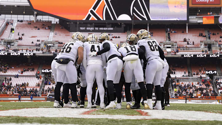 Dec 24, 2022; Cleveland, Ohio, USA; The New Orleans Saints offense huddles together in the end zone during the first quarter against the Cleveland Browns at FirstEnergy Stadium. Mandatory Credit: Scott Galvin-Imagn Images
