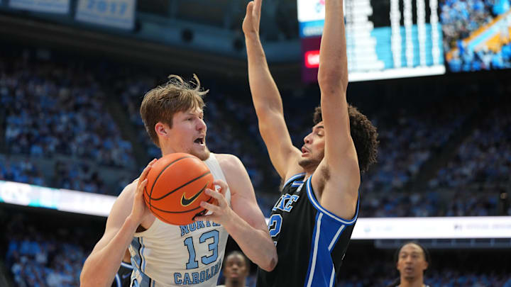 Feb 7, 2026; Chapel Hill, North Carolina, USA; North Carolina Tar Heels center Henri Veesaar (13) with the ball as Duke Blue Devils forward Cameron Boozer (12) defends in the second  half at Dean E. Smith Center. Mandatory Credit: Bob Donnan-Imagn Images