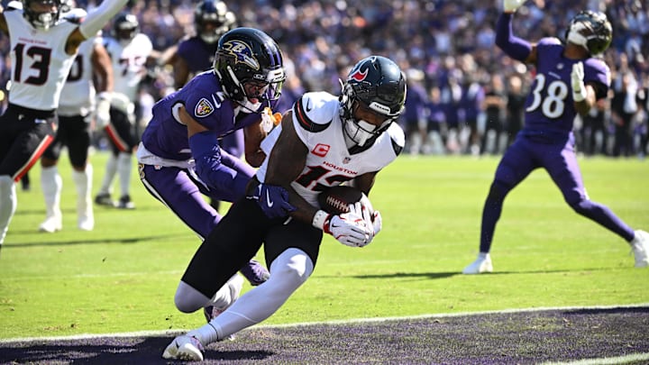 Oct 5, 2025; Baltimore, Maryland, USA; Houston Texans wide receiver Nico Collins (12) runs for a touchdown past Baltimore Ravens cornerback Nate Wiggins (2) during the second quarter at M&T Bank Stadium. Mandatory Credit: Rafael Suanes-Imagn Images