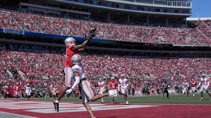 April 13, 2024; Columbus, Ohio, USA; 
Ohio State Buckeyes wide receiver Jeremiah Smith (4) playing for the scarlet team can't reel in a pass while defended by cornerback Davison Igbinosun (1) of the gray team of the during the first half of the LifeSports Spring Game at Ohio Stadium on Saturday. Despite the Spring Game being televised for the first time there were still plenty of fans in the stands at Ohio Stadium.