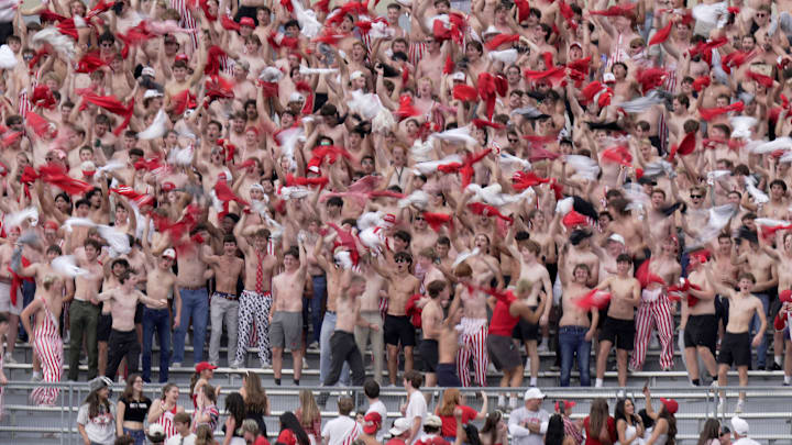 Spectators in the student section take off their shirts and cheers during the third quarter of the Wisconsin - Ohio State game Saturday, October 18, 2025 at Camp Randall Stadium in Madison, Wisconsin.