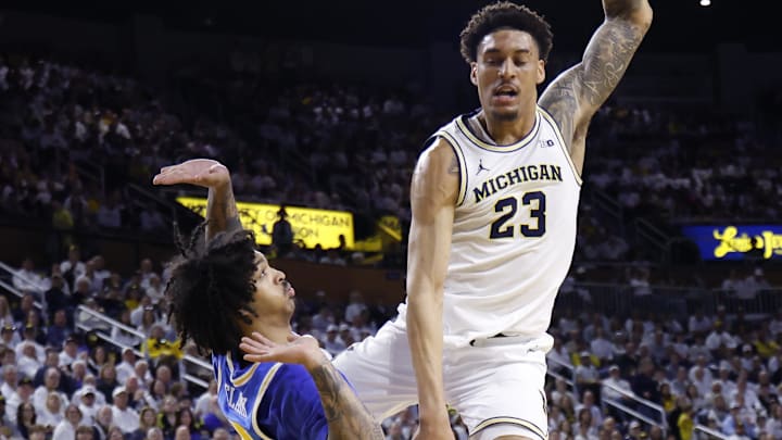 Feb 14, 2026; Ann Arbor, Michigan, USA; Michigan Wolverines forward Yaxel Lendeborg (23) is fouled by UCLA Bruins guard Skyy Clark (55) in the first half at Crisler Center. Mandatory Credit: Rick Osentoski-Imagn Images