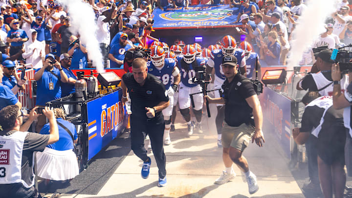 Florida Gators head coach Billy Napier runs out of the tunnel with his team during the season opener at Ben Hill Griffin Stadium in Gainesville, FL on Saturday, August 31, 2024 against the University of Miami Hurricanes. The Hurricanes defeated the Gators 41-17. [Doug Engle/Gainesville Sun]
