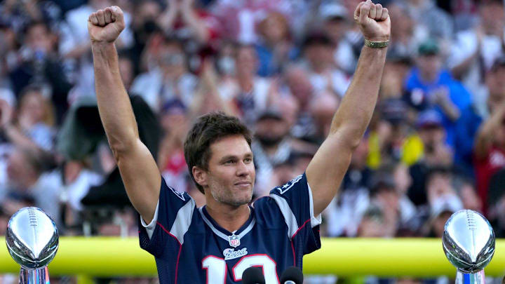 Tom Brady acknowledges his fans during a halftime celebration and the announcement of his induction in the Patriots Hall of Fame.