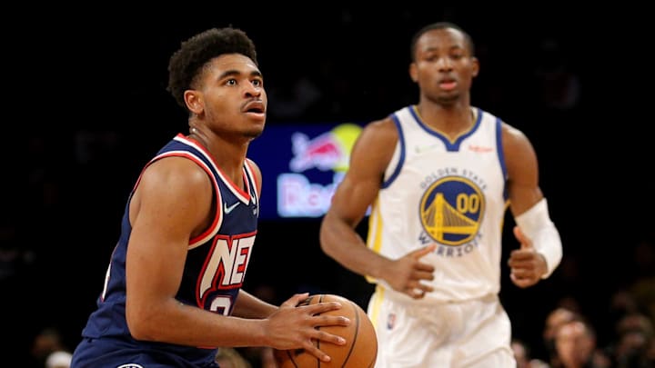 Nov 16, 2021; Brooklyn, New York, USA; Brooklyn Nets guard Cam Thomas (24) pulls up for a shot against Golden State Warriors forward Jonathan Kuminga (00) during the fourth quarter at Barclays Center. Mandatory Credit: Brad Penner-Imagn Images