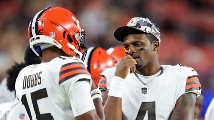 Browns quarterback Deshaun Watson (4) talks with fellow QB Joshua Dobbs during the first half.