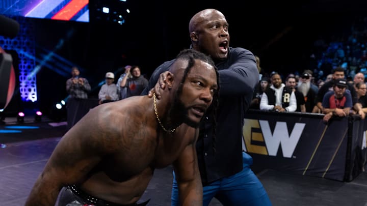 Bobby Lashley (top) about to throw Swerve Strickland (bottom) into the ring. Bobby Lashley (top) about to throw Swerve Strickland (bottom) into the ring.