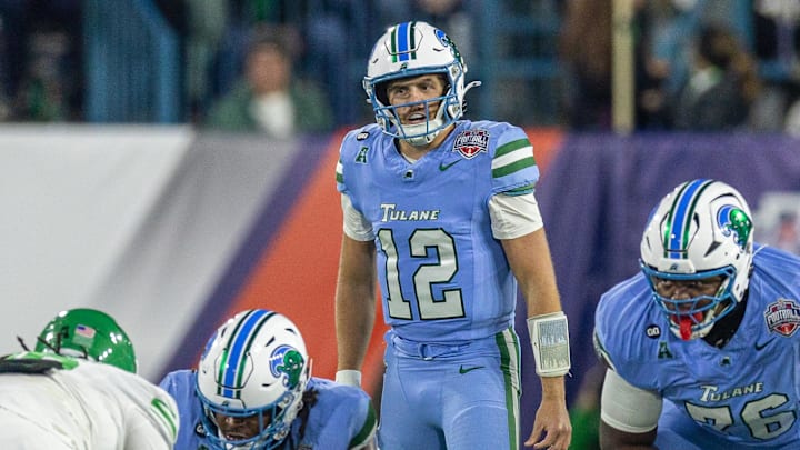 Dec 5, 2025; New Orleans, LA, USA; Tulane Green Wave quarterback Jake Retzlaff (12) looks on against the North Texas Mean Green during the first half in the 2025 American Championship at Yulman Stadium. Mandatory Credit: Stephen Lew-Imagn Images Dec 5, 2025; New Orleans, LA, USA; Tulane Green Wave quarterback Jake Retzlaff (12) looks on against the North Texas Mean Green during the first half in the 2025 American Championship at Yulman Stadium. Mandatory Credit: Stephen Lew-Imagn Images