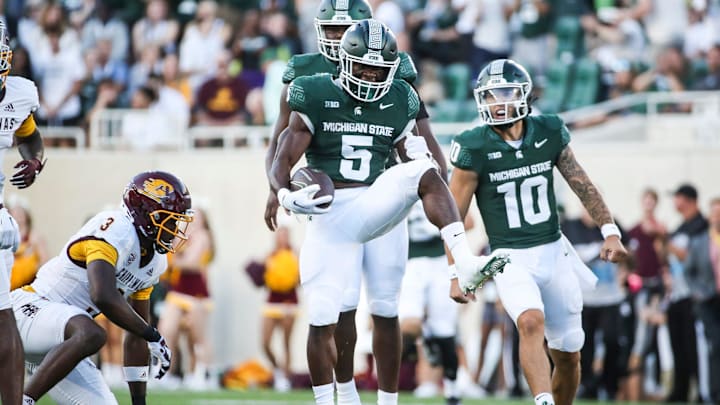 Michigan State running back Nathan Carter (5) celebrates his 31-yard run on the first offensive play of the season against Central Michigan at Spartan Stadium in East Lansing on Friday, Sept. 1, 2023.