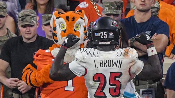 Louisville freshman Isaac Brown flexes for the Clemson mascot after scoring a touchdown