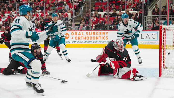 Dec 7, 2025; Raleigh, North Carolina, USA; San Jose Sharks center Alexander Wennberg (21) scores a goal past Carolina Hurricanes goaltender Pyotr Kochetkov (52) during the second period at Lenovo Center. Mandatory Credit: James Guillory-Imagn Images Dec 7, 2025; Raleigh, North Carolina, USA; San Jose Sharks center Alexander Wennberg (21) scores a goal past Carolina Hurricanes goaltender Pyotr Kochetkov (52) during the second period at Lenovo Center. Mandatory Credit: James Guillory-Imagn Images