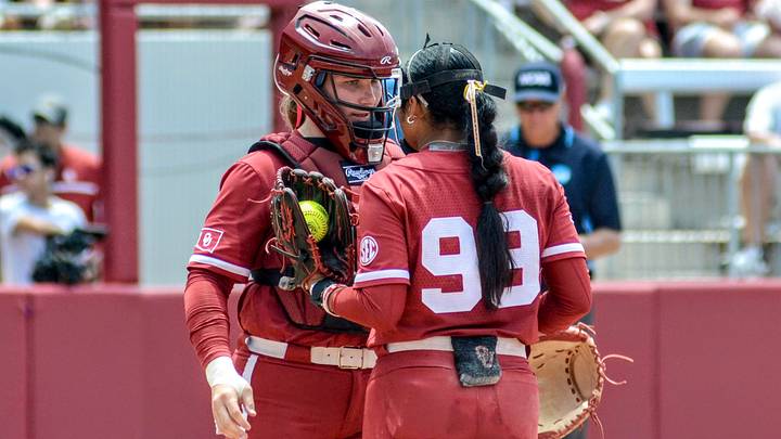 Oklahoma catcher Kendall Wells speaks with Miali Guachino during Game 3 of the Norman Super Regional against Mississippi State. Oklahoma catcher Kendall Wells speaks with Miali Guachino during Game 3 of the Norman Super Regional against Mississippi State.