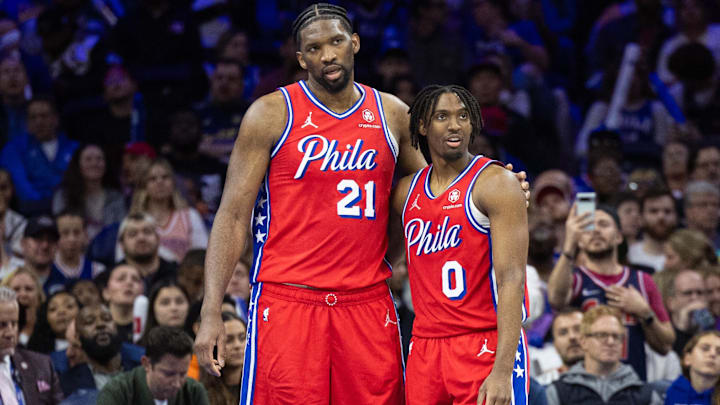Apr 12, 2024; Philadelphia, Pennsylvania, USA; Philadelphia 76ers center Joel Embiid (21) and guard Tyrese Maxey (0) stand together during a break in action in the fourth quarter against the Orlando Magic at Wells Fargo Center. Mandatory Credit: Bill Streicher-Imagn Images