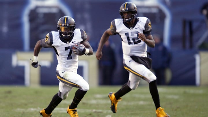 Nov 26, 2010; Pittsburgh, PA, USA; West Virginia Mountaineers running back Noel Devine (7) and quarterback Geno Smith run up field against the Pittsburgh Panthers during the fourth quarter at Heinz Field. West Virginia won 35-10.Mandatory Credit: Charles LeClaire-USPRESSWIRE
