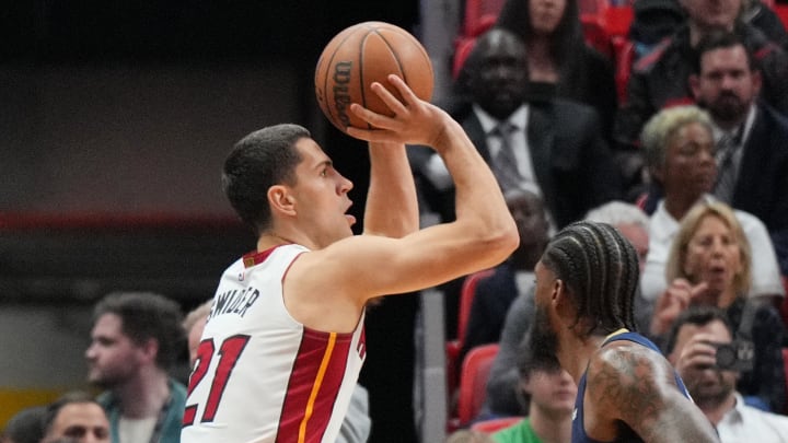 Mar 22, 2024; Miami, Florida, USA; Miami Heat forward Cole Swider (21) attempts a three-point shot over New Orleans Pelicans forward Naji Marshall (8) during the first half at Kaseya Center. Mandatory Credit: Jim Rassol-USA TODAY Sports Mar 22, 2024; Miami, Florida, USA; Miami Heat forward Cole Swider (21) attempts a three-point shot over New Orleans Pelicans forward Naji Marshall (8) during the first half at Kaseya Center. Mandatory Credit: Jim Rassol-USA TODAY Sports