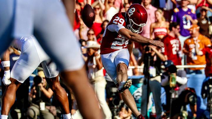 Oklahoma kicker Tate Sandell kicks off against Texas.