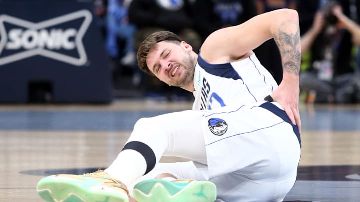 Dec 11, 2023; Memphis, Tennessee, USA; Dallas Mavericks guard Luka Doncic (77) reacts after a fall during the first half against the Memphis Grizzlies at FedExForum. Mandatory Credit: Petre Thomas-Imagn Images Dec 11, 2023; Memphis, Tennessee, USA; Dallas Mavericks guard Luka Doncic (77) reacts after a fall during the first half against the Memphis Grizzlies at FedExForum. Mandatory Credit: Petre Thomas-Imagn Images