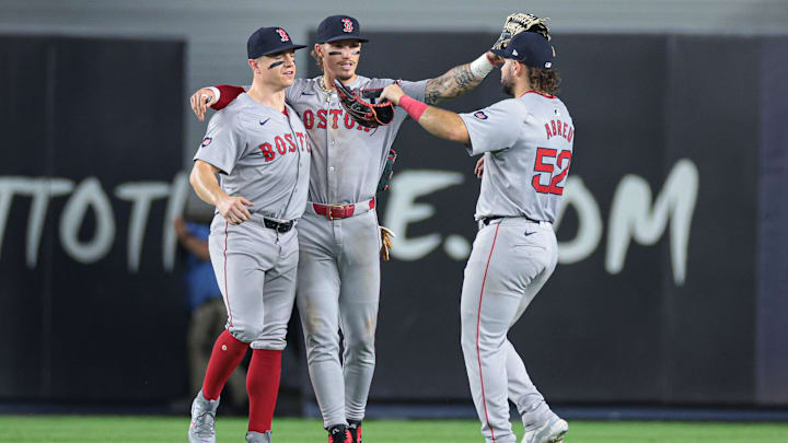 Jul 7, 2024; Bronx, New York, USA; Boston Red Sox left fielder Tyler O'Neill (17) celebrates with center fielder Jarren Duran (16) and right fielder Wilyer Abreu (52) after defeating the New York Yankees at Yankee Stadium. Mandatory Credit: Vincent Carchietta-Imagn Images