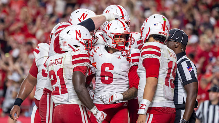 Nebraska players celebrate with wide receiver Dane Key after Key's 3-yard touchdown catch put the Huskers up 19-10 against Cincinnati.