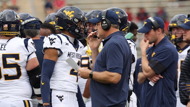 Nov 1, 2025; Houston, Texas, USA; West Virginia Mountaineers head coach Rich Rodriguez talks to wide receiver Cam Vaughn (4) during an official timeout against the Houston Cougars  in the first half at TDECU Stadium. Mandatory Credit: Thomas Shea-Imagn Images