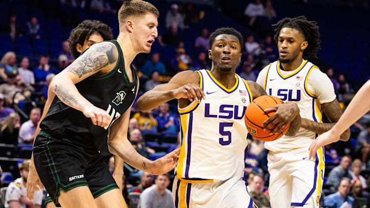 Dec 17, 2024; Baton Rouge, Louisiana, USA;  LSU Tigers guard Cam Carter (5) dribbles against Stetson Hatters forward Treyton Thompson (42) during the first half at Pete Maravich Assembly Center. Mandatory Credit: Stephen Lew-Imagn Images