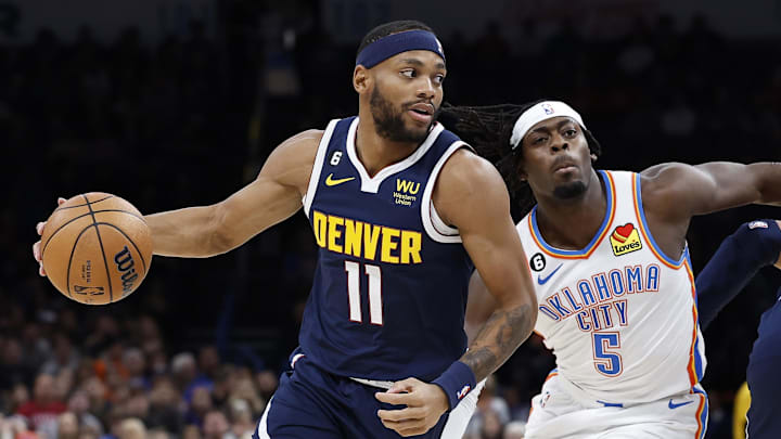 Nov 23, 2022; Oklahoma City, Oklahoma, USA; Denver Nuggets forward Bruce Brown (11) dribbles the ball around Oklahoma City Thunder forward Luguentz Dort (5) during the first quarter at Paycom Center. Mandatory Credit: Alonzo Adams-Imagn Images