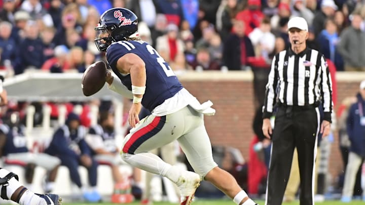 Nov 29, 2024; Oxford, Mississippi, USA;  Mississippi Rebels quarterback Jaxson Dart (2) runs the ball against the Mississippi State Bulldogs during the second quarter at Vaught-Hemingway Stadium. Mandatory Credit: Matt Bush-Imagn Images