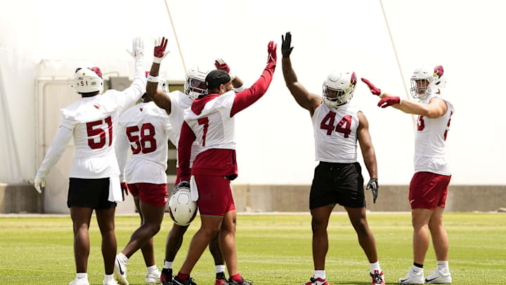 Arizona Cardinals linebacker Kyzir White (7) high-fives linebacker Owen Pappoe (44) during organized team activities in Tempe on May 20, 2024.
