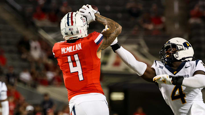 Oct 26, 2024; Tucson, Arizona, USA; Arizona Wildcats wide receiver Tetairoa McMillan (4) catches a long pass while West Virginia Mountaineers linebacker Trey Lathan (4) fails to defend against him during the fourth quarter at Arizona Stadium. Mandatory Credit: Aryanna Frank-Imagn Images