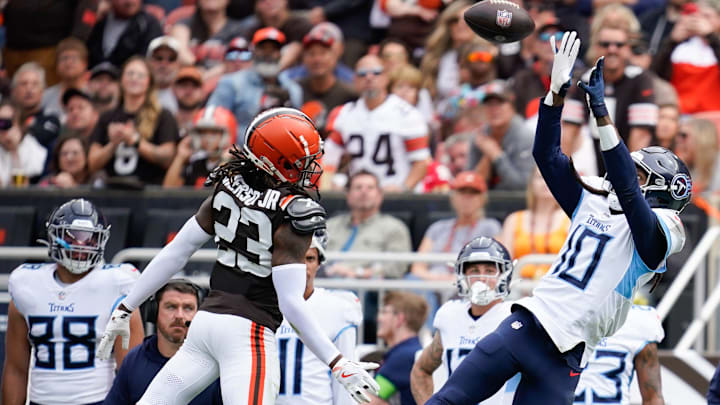 Tennessee Titans wide receiver DeAndre Hopkins (10) pulls in a catch under pressure from Cleveland Browns cornerback Martin Emerson Jr. (23) during the second quarter in Cleveland, Ohio, Sunday, Sept. 24, 2023.