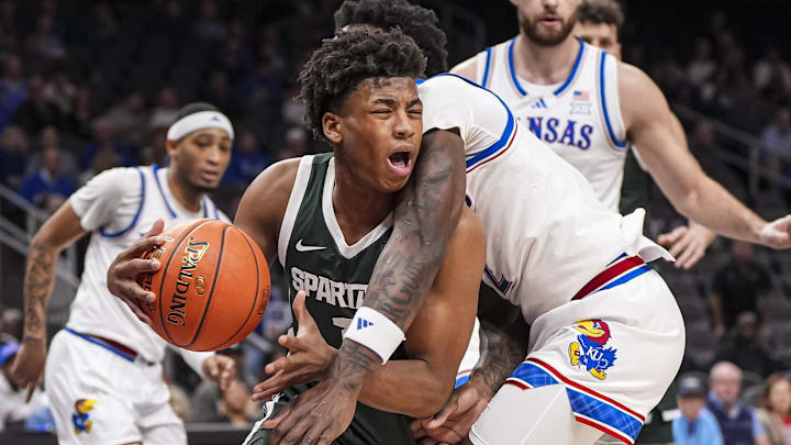Nov 12, 2024; Atlanta, Georgia, USA; Michigan State Spartans guard Jeremy Fears Jr. (1) collides with Kansas Jayhawks guard AJ Storr (2) during the first half at State Farm Arena. Mandatory Credit: Dale Zanine-Imagn Images