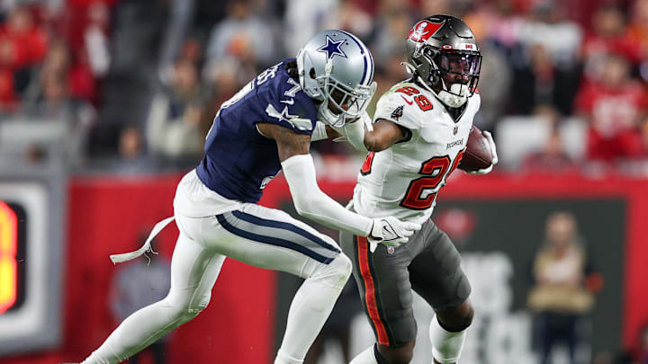 Jan 16, 2023; Tampa, Florida, USA; Tampa Bay Buccaneers running back Rachaad White (29) holds off Dallas Cowboys cornerback Trevon Diggs (7) in the fourth quarter during a wild card game at Raymond James Stadium. Mandatory Credit: Nathan Ray Seebeck-Imagn Images Jan 16, 2023; Tampa, Florida, USA; Tampa Bay Buccaneers running back Rachaad White (29) holds off Dallas Cowboys cornerback Trevon Diggs (7) in the fourth quarter during a wild card game at Raymond James Stadium. Mandatory Credit: Nathan Ray Seebeck-Imagn Images