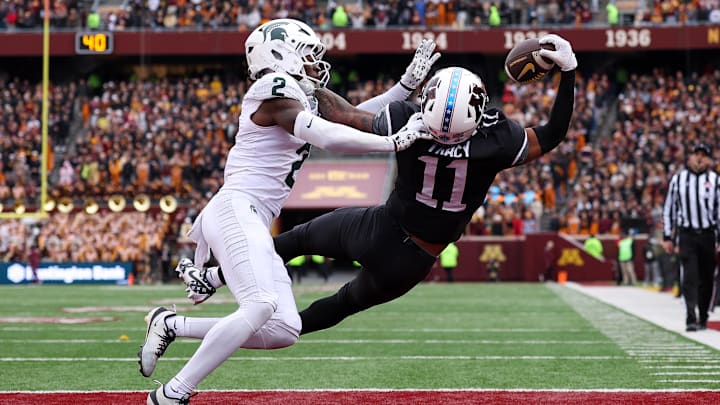 Nov 1, 2025; Minneapolis, Minnesota, USA; Minnesota Golden Gophers wide receiver Javon Tracy (11) attempts to catch a pass as Michigan State Spartans defensive back Aydan West (2) defends during the first half at Huntington Bank Stadium. Mandatory Credit: Matt Krohn-Imagn Images