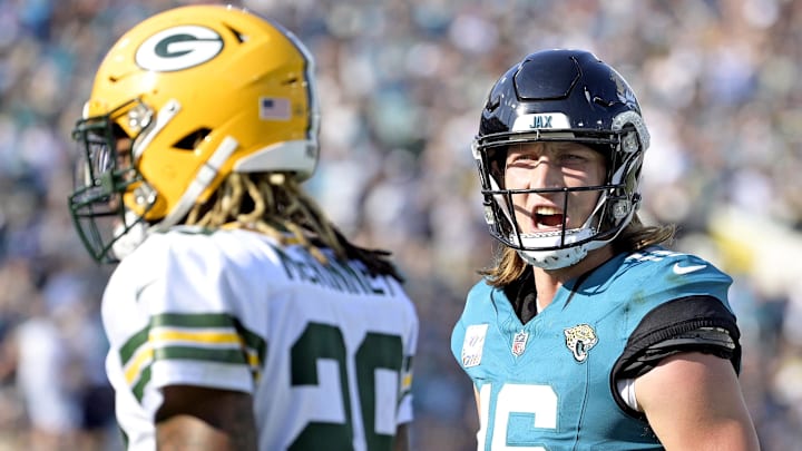 Oct 27, 2024; Jacksonville, Florida, USA; Jacksonville Jaguars quarterback Trevor Lawrence (16) speaks to Green Bay Packers safety Xavier McKinney (29) after a touchdown pass during the fourth quarter at EverBank Stadium. Mandatory Credit: Melina Myers-Imagn Images