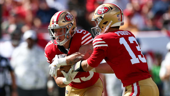 Nov 10, 2024; Tampa, Florida, USA; San Francisco 49ers quarterback Brock Purdy (13) hands off to running back Christian McCaffrey (23) against the Tampa Bay Buccaneers in the first quarter at Raymond James Stadium. Mandatory Credit: Nathan Ray Seebeck-Imagn Images