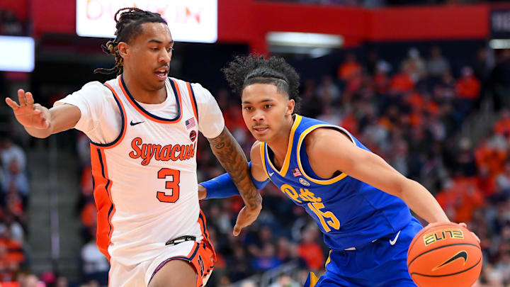 Jan 25, 2025; Syracuse, New York, USA; Pittsburgh Panthers guard Jaland Lowe (15) drives against Syracuse Orange guard Lucas Taylor (3) during the first half at the JMA Wireless Dome. Mandatory Credit: Rich Barnes-Imagn Images