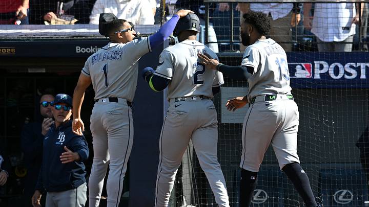 Oct 15, 2026: Tampa Bay Rays second baseman Richie Palacios (1) and third baseman Junior Caminero (13) congratulate designated hitter Yandy Diaz (2) on scoring a run against the Cleveland Guardians during the fourth inning in game three of the ALCS for the 2026 MLB Playoffs at Progressive Field. Credit: Ken Blaze-Imagn Images