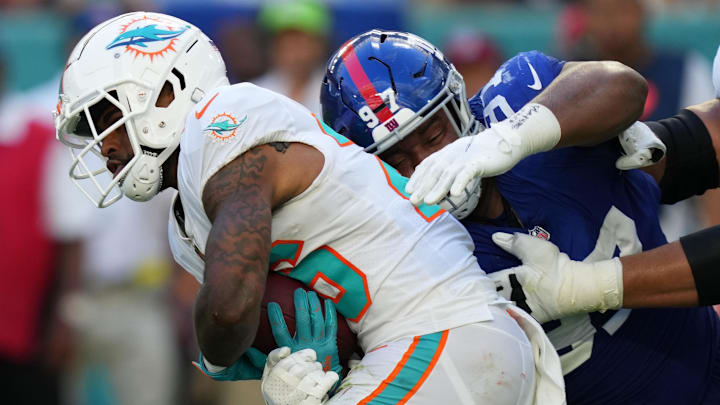 New York Giants defensive tackle Dexter Lawrence (97) wraps up Miami Dolphins running back Salvon Ahmed during the second half at Hard Rock Stadium during a 2021 game.