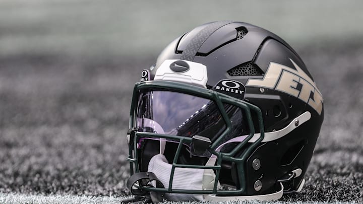 Dec 7, 2025; East Rutherford, New Jersey, USA; A general view of a Gotham City football rivalries helmet resting on the field before the game against the Miami Dolphins at MetLife Stadium. Mandatory Credit: Vincent Carchietta-Imagn Images