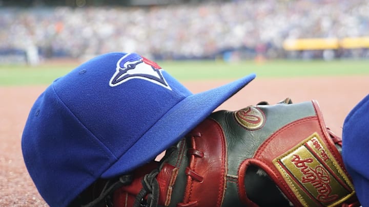 Jul 26, 2024; Toronto, Ontario, CAN; A Toronto Blue Jays hat and glove outside of the dugout during a game against the Texas Rangers at Rogers Centre. Mandatory Credit: John E. Sokolowski-Imagn Images