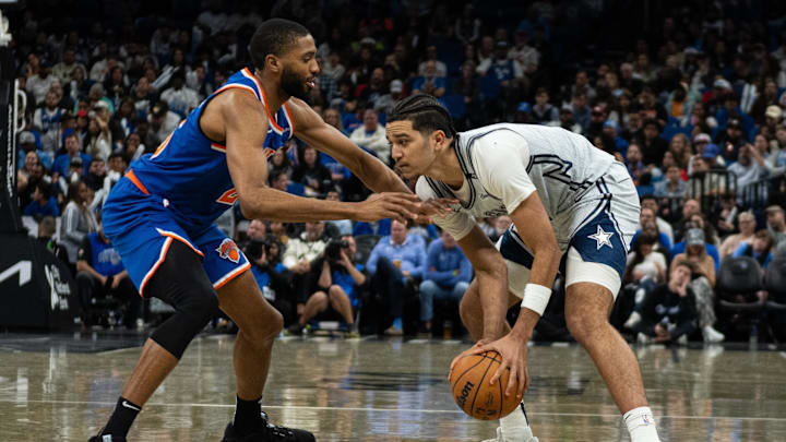 Dec 15, 2024; Orlando, Florida, USA; Orlando Magic guard Anthony Black (0) dribbles the ball against New York Knicks guard Mikal Bridges (25) in the fourth quarter at Kia Center. Mandatory Credit: Jeremy Reper-Imagn Images