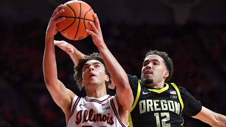 Mar 3, 2026; Champaign, Illinois, USA; Oregon Ducks guard Drew Carter (12) tries to block Illinois Fighting Illini guard Keaton Wagler (23) during the first half at State Farm Center. Mandatory Credit: Ron Johnson-Imagn Images Mar 3, 2026; Champaign, Illinois, USA; Oregon Ducks guard Drew Carter (12) tries to block Illinois Fighting Illini guard Keaton Wagler (23) during the first half at State Farm Center. Mandatory Credit: Ron Johnson-Imagn Images