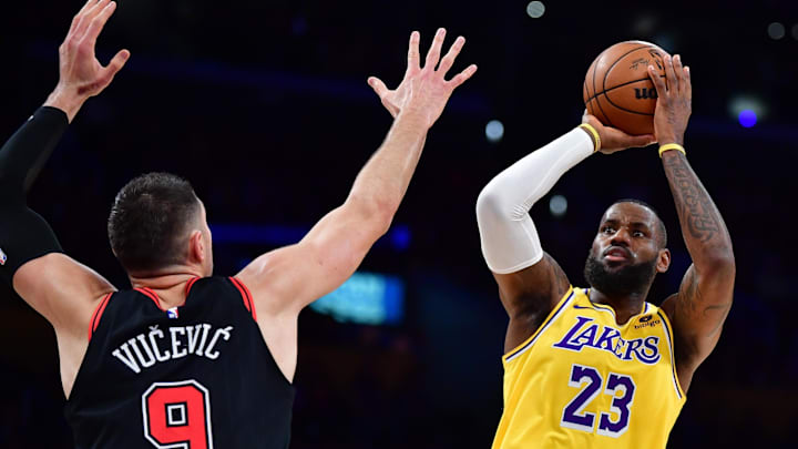 Jan 25, 2024; Los Angeles, California, USA; Los Angeles Lakers forward LeBron James (23) shoots against Chicago Bulls center Nikola Vucevic (9) during the first half at Crypto.com Arena. Mandatory Credit: Gary A. Vasquez-Imagn Images