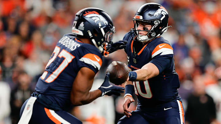 Sep 29, 2025; Denver, Colorado, USA; Denver Broncos quarterback Bo Nix (10) hands the ball off to Denver Broncos running back J.K. Dobbins (27) during the third quarter against the Cincinnati Bengals at Empower Field at Mile High. Sep 29, 2025; Denver, Colorado, USA; Denver Broncos quarterback Bo Nix (10) hands the ball off to Denver Broncos running back J.K. Dobbins (27) during the third quarter against the Cincinnati Bengals at Empower Field at Mile High.