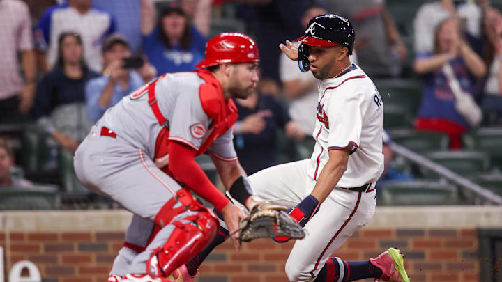 May 8, 2025; Atlanta, Georgia, USA; Atlanta Braves outfielder Eddie Rosario (9) scores a run past Cincinnati Reds catcher Austin Wynns (38) in the ninth inning at Truist Park. Mandatory Credit: Brett Davis-Imagn Images
