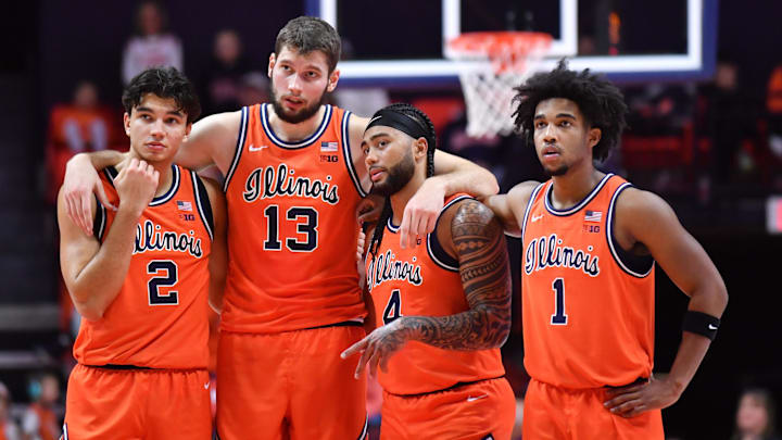 Nov 22, 2025; Champaign, Illinois, USA;  Illinois fighting Illini players  Andrej Stojakovic (2) Tomislav Ivisic (13)  guard Kylan Boswell (4) and Brandon Lee (1) stand while teammate  Ben Humrichhous (3) shoots for a technical foul on the Long Island University Sharks during the first half at State Farm Center. Mandatory Credit: Ron Johnson-Imagn Images