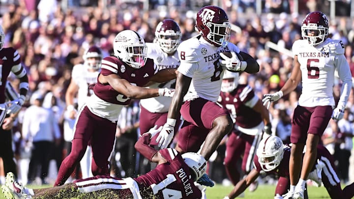 Oct 19, 2024; Starkville, Mississippi, USA; Texas A&M Aggies running back Le'Veon Moss (8) runs the ball against Mississippi State Bulldogs cornerback Brice Pollock (14) during the first quarter at Davis Wade Stadium at Scott Field. Oct 19, 2024; Starkville, Mississippi, USA; Texas A&M Aggies running back Le'Veon Moss (8) runs the ball against Mississippi State Bulldogs cornerback Brice Pollock (14) during the first quarter at Davis Wade Stadium at Scott Field.