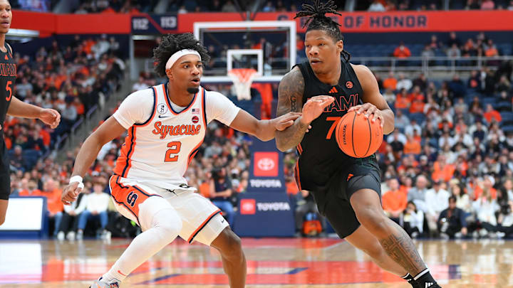 Jan 24, 2026; Syracuse, New York, USA; Miami Hurricanes forward Shelton Henderson (7) drives against Syracuse Orange guard J.J. Starling (2) during the first half at the JMA Wireless Dome. Mandatory Credit: Rich Barnes-Imagn Images